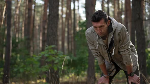 Tired Male Hiker Standing in Forest Outdoors Resting