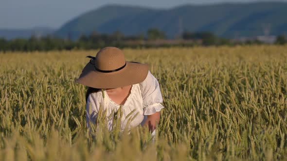 Young Girl Walking in Slow Motion Through a Wheat Field