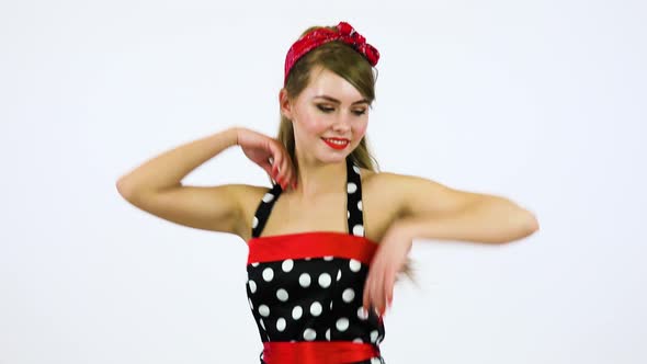 A Beautiful 50s Pin-up Girl Spins Around, Dances and Smiles at the Camera White Screen Background