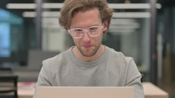 Portrait of Businessman Talking on Video Call on Laptop