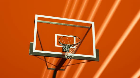 Basketball hoop in an orange gym. Colourful dynamic abstract surrounding. 4KHD