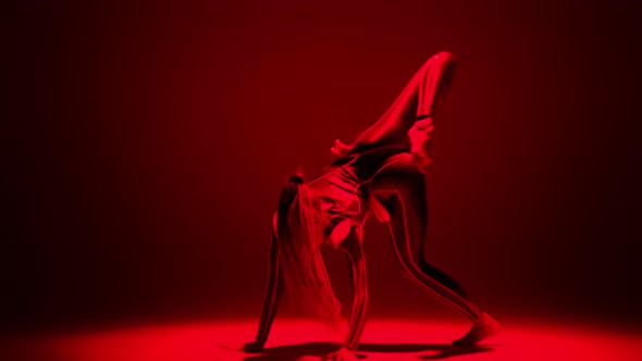 Wide Shot Sensual Flexible Woman Dancing in Red Neon Light Bending Doing Back Walkover Looking at