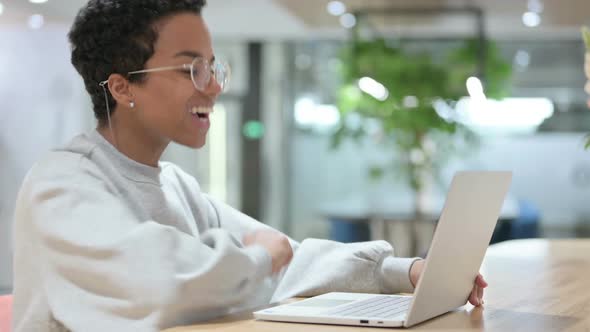 Video Chat on Laptop By Casual African Woman