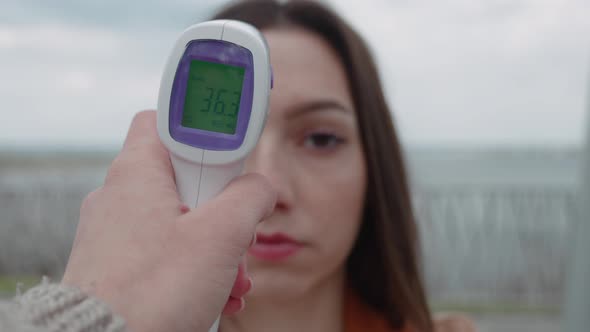 Patient Beautiful Woman Face and Doctor Hand with Thermometer Check Temperature