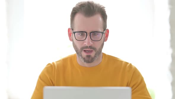 Portrait of Man Celebrating Success on Laptop