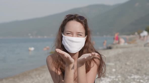 Young Attractive Mixed Race Girl Enjoying Beach Holidays in Bikini and Sending Safe Air Kiss to