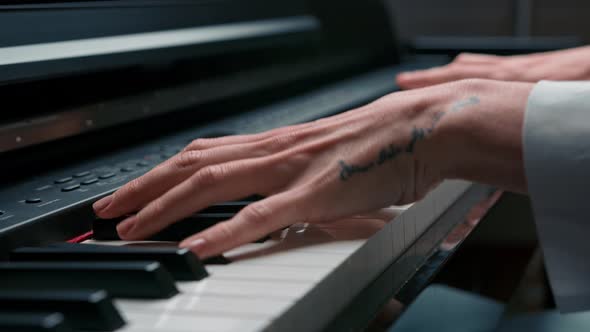 Selective focus to piano key and fingers to play the piano. There are musical instrument for concert