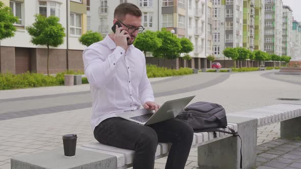 Young Freelancer Working on Laptop Outdoors