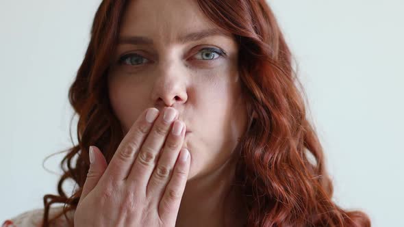 Portrait of a Smiling Woman Sending the Air Kiss at the Camera