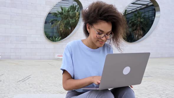 Beautiful Positive Confident African American Curly Haired Young Woman with Glasses Manager Company