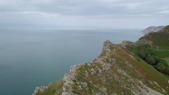 Aerial shot tracking from right to left acorss the cliffs at the Valley of Rocks in Exmoor. revealin