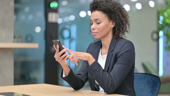 Attractive African Businesswoman Using Smartphone 