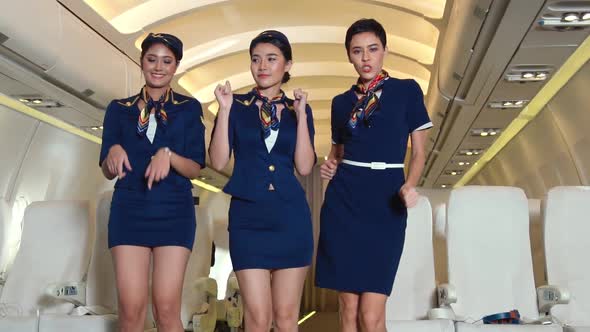 Cabin Crew Dancing with Joy in Airplane