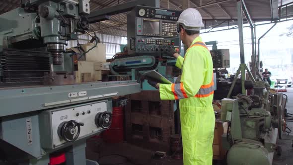 Smart Factory Worker Using Machine in Factory Workshop