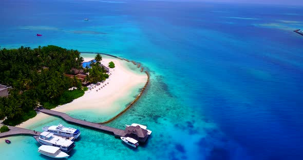 Tropical overhead abstract shot of a sandy white paradise beach and blue water background in colorfu