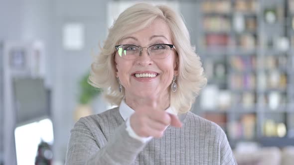 Portrait of Cheerful Old Woman Pointing Finger at the Camera