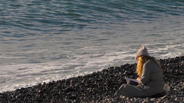 Girl Reading a Book By the Sea