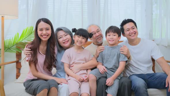 Portrait of Multi-Generation Asian happy family spend time together in living room at home.