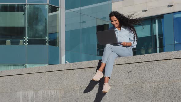 Happy Joyful Business Woman Freelancer Girl Student Sit in City with Laptop Reads Good News Wins