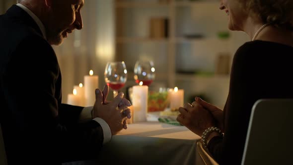 Handsome Old Man Presenting Gift to Elegant Lady, Dating Couple in Restaurant