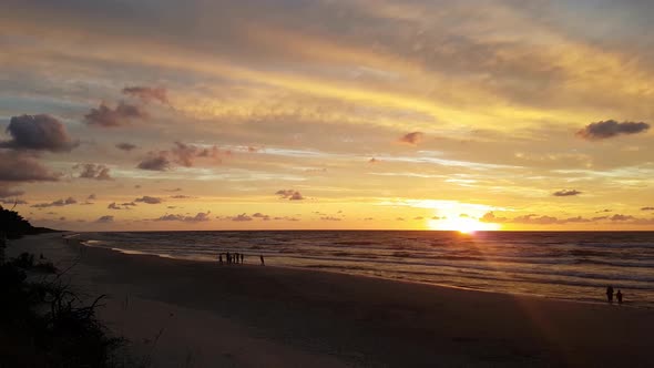 Sunset at the Lubiatowo Beach, Baltic Sea, Poland. Beautiful colours. Group of people in the distanc