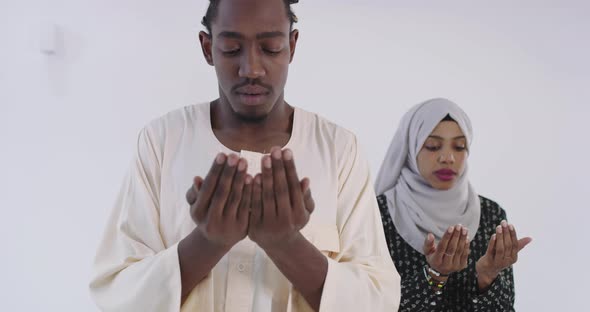 African Black Muslim Couple at Home in Ramadan Making Traditional Fatiha Prayer To Allah God While