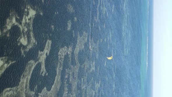 Vertical Video Kitesurfing Near the Shore of Zanzibar Tanzania Aerial View