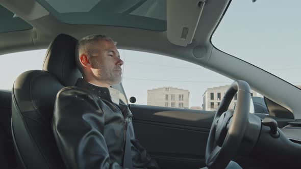 Man Relaxing in Self-Driving Car