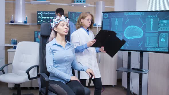 Female Patient with Eyes Closed Wearing Brainwaves Scaning Headset