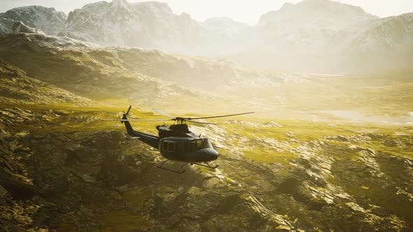 Slow Motion Vietnam War Era Helicopter in Mountains