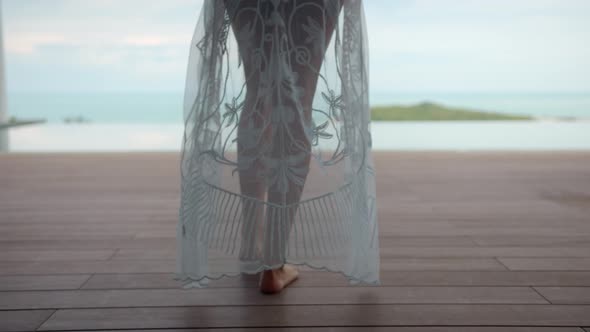 Woman Walks to the Pool Her White Swimsuit CoverUps Falls on the Floor