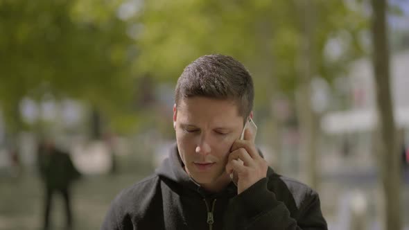 Happy Young Man Talking By Smartphone Outdoor