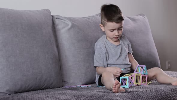 UhA little boy gaming with magnetic constructor. Creativity development. Magnetic constructor.