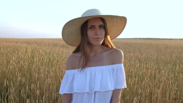 Amazing Portrait of Beautiful Woman Standing in Field of Ripe Golden Wheat