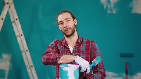 Posing Man in Front of the Camera Holding a Box of