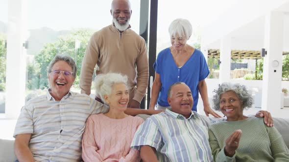 Portrait of senior diverse people embracing at retirement home