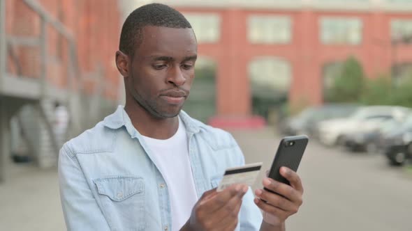 Outdoor African Man Shopping Online on Smartphone