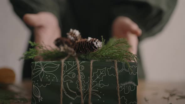 A Christmas Present Moves a Woman's Hands Into the Camera