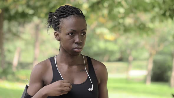 concentration, sport.Athlete African woman wearing headphones