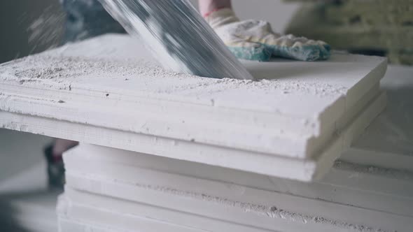 Worker in Gloves Prepares and Saws Gypsum Plasterboard