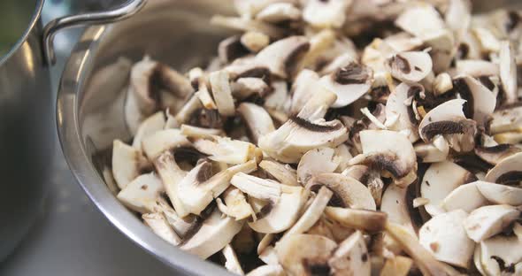 Chef Slicing Mushrooms in Kitchen