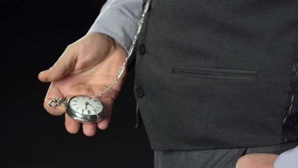 Man Pulls Out of His Pocket a Watch on a Chain That Looks at the Time. Black Background. Sound