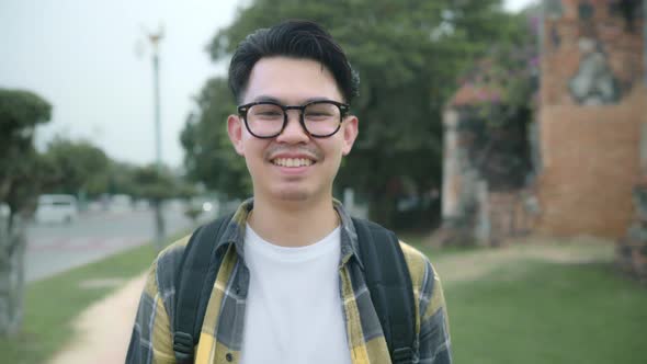 Traveler Asian man feeling happy smiling to camera holiday trip at Ayutthaya, Thailand