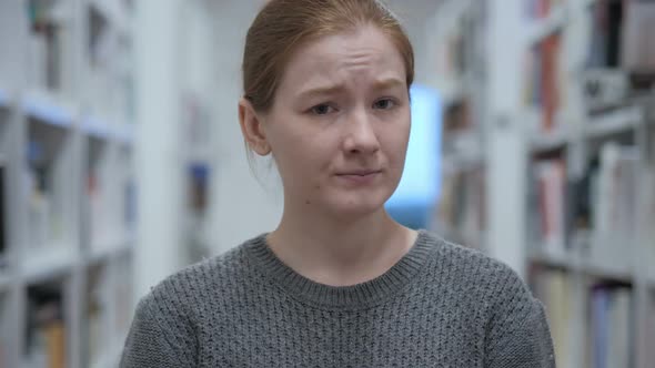 Young Woman Shaking Head to Reject Offer No