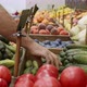 Close-up hands of grocery worker is arranging cucumbers on store shelves - VideoHive Item for Sale