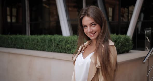 Portrait of Attractive Young Woman with Brunnette Hair Posing and Looking To Camera. Crop View of