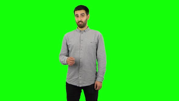 Brunette Guy Is Talking and Pointing Side Hand for Something and Showing Thumb Up Like. Green Screen