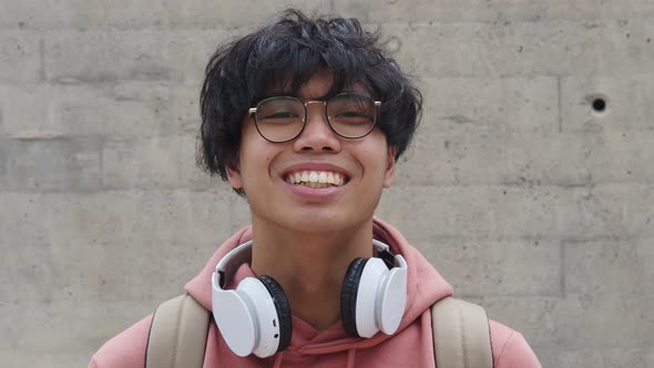 Portrait of a Young Asian Man Smiling with Headphones