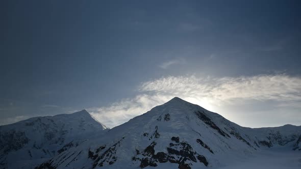 Clouds move over snow-capped mountain peaks in Denali National Park, Alaska, USA