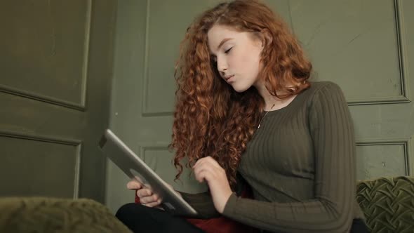 Brunette Girl with Braces Using Tablet